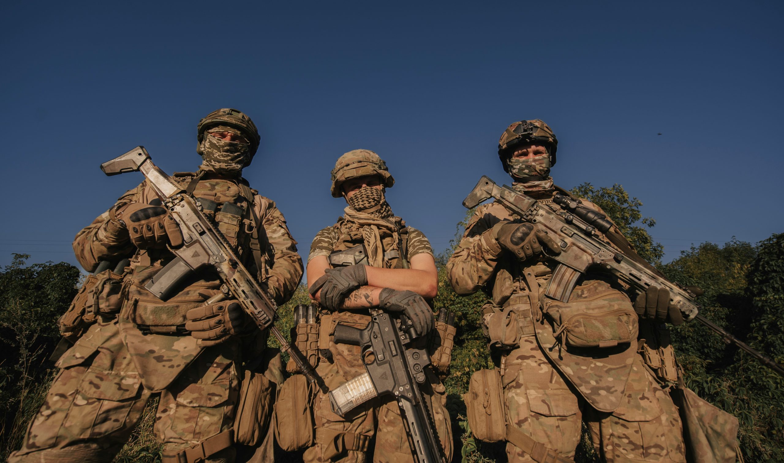A group of Ukrainian troops in camouflage uniforms holding guns.