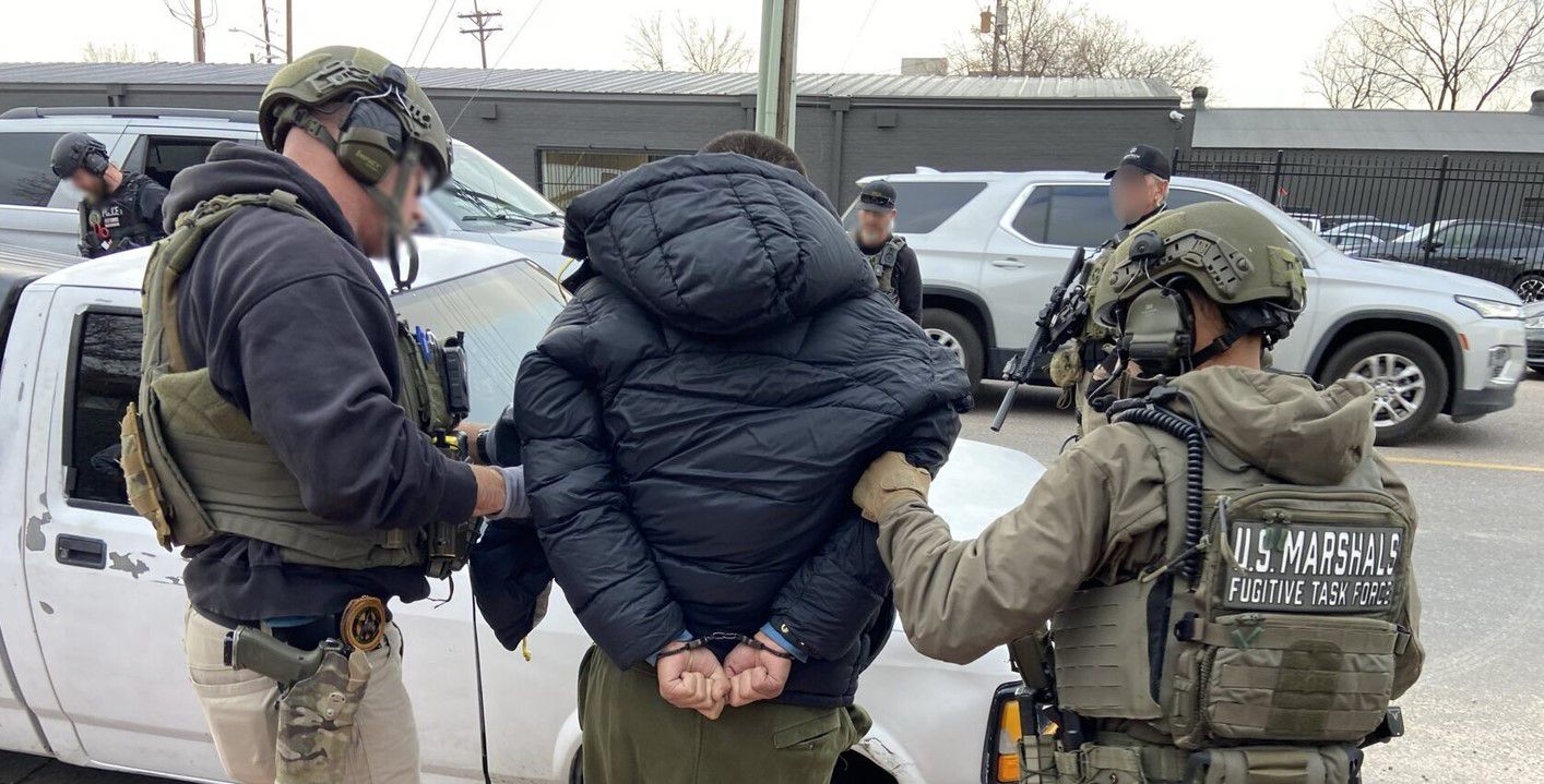 Jared Brooks, center, is taken into custody by U.S. Marshals Service task force members in Denver, Colorado, on Nov. 21, 2025. U.S. Marshals Service.