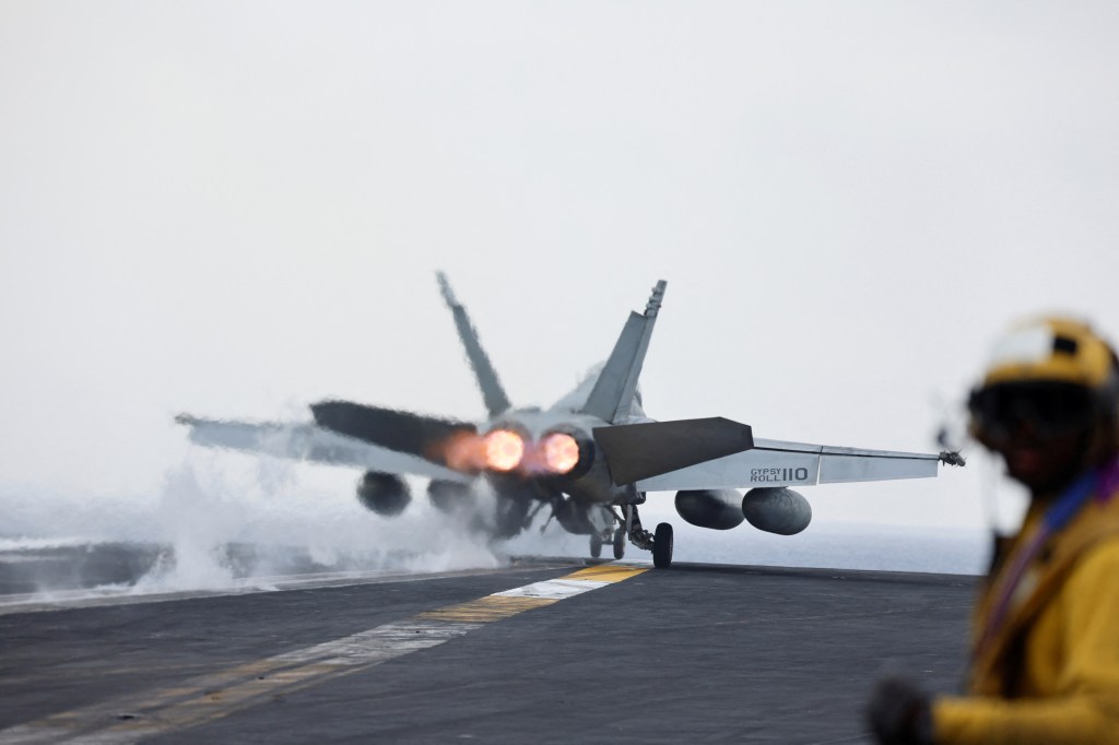 A F/A-18E Super Hornet fighter jet is catapulted off the flight deck of the USS Dwight D. Eisenhower aircraft carrier.