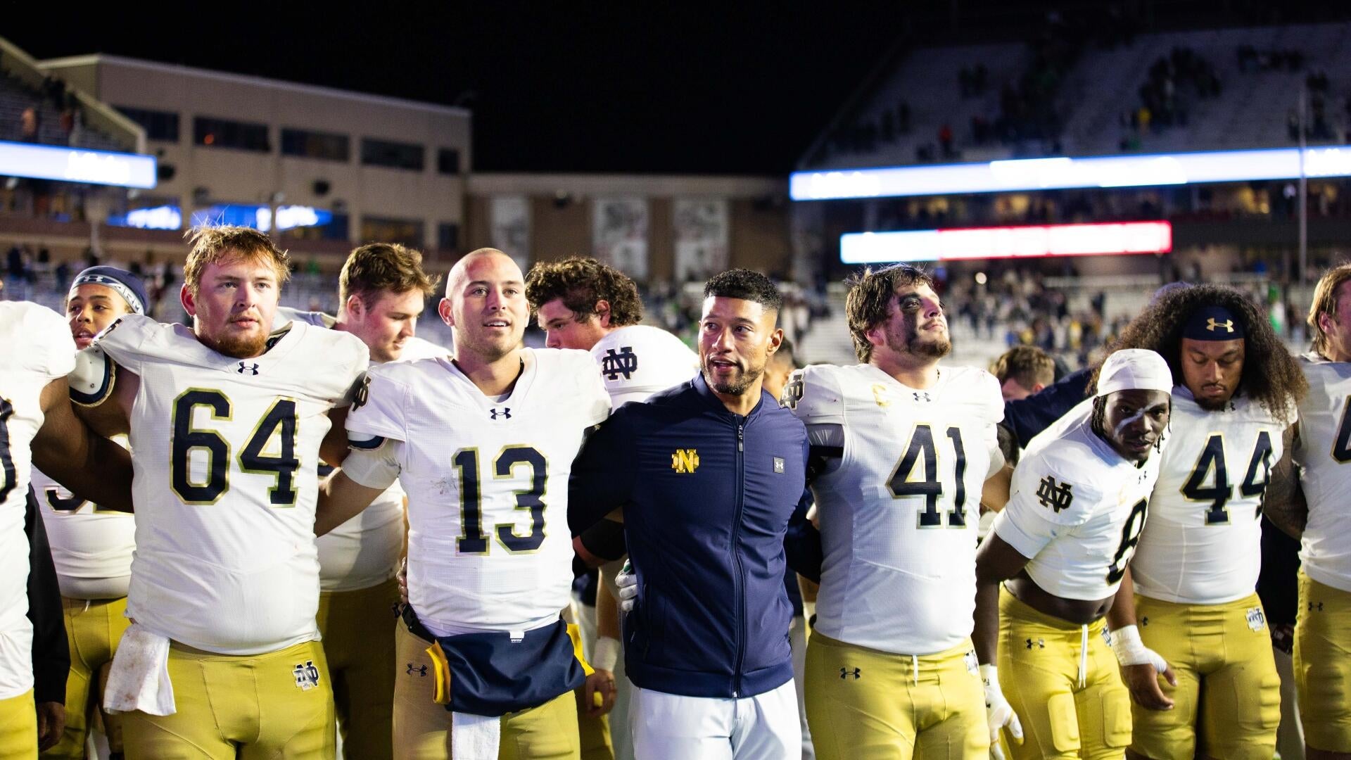 Notre Dame players, white and yellow dress.